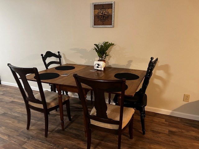 dining area featuring dark hardwood / wood-style floors