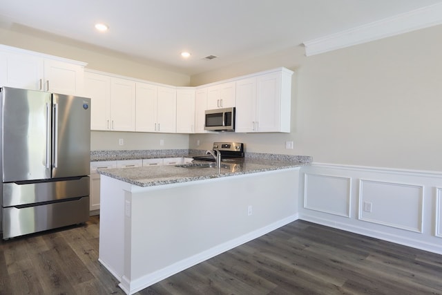 65 Hood Park Ct, Jasper, GA 30143 - kitchen with appliances with stainless steel finishes, dark wood-type flooring, white cabinetry, light stone counters, and a peninsula