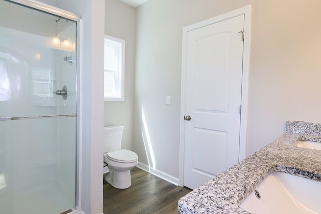 65 Hood Park Ct, Jasper, GA 30143 - full bathroom featuring a stall shower, wood finished floors, toilet, vanity, and baseboards
