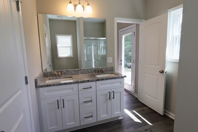 65 Hood Park Ct, Jasper, GA 30143 - full bath featuring wood finished floors, double vanity, a shower with door, and baseboards