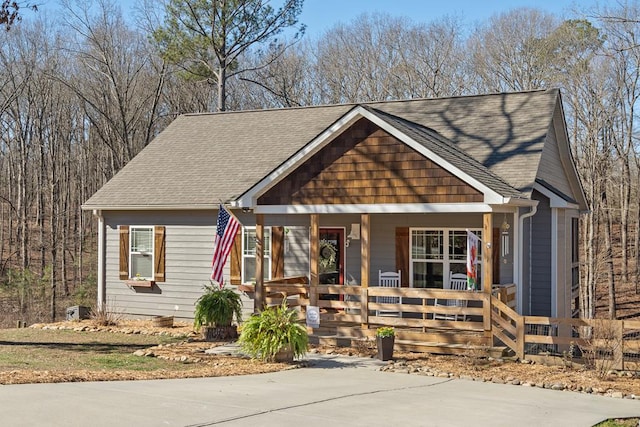 view of front of house featuring a porch and roof with shingles