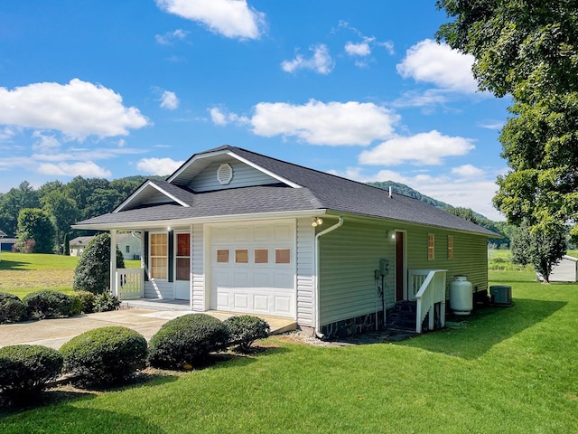 exterior space with central air condition unit, a yard, and a porch