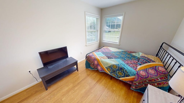 bedroom with hardwood / wood-style flooring