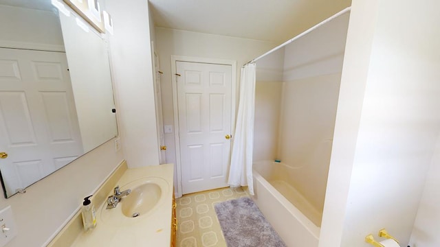 bathroom featuring shower / bath combination with curtain and sink