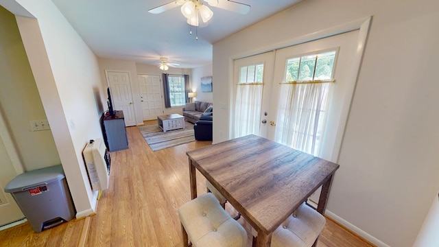 dining space with a healthy amount of sunlight, ceiling fan, and light hardwood / wood-style floors