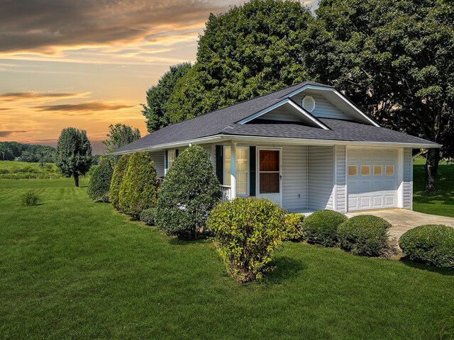 property exterior at dusk featuring covered porch and a lawn