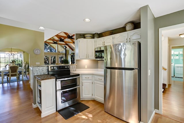 14 Rivendell Dr, Hayesville, NC 28904 - kitchen with stainless steel appliances, independent washer and dryer, white cabinets, light wood-style flooring, and a chandelier