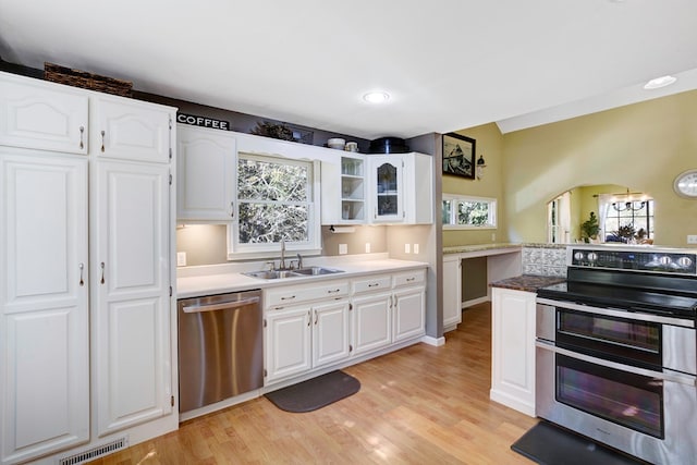 14 Rivendell Dr, Hayesville, NC 28904 - kitchen with appliances with stainless steel finishes, a sink, white cabinets, light wood-type flooring, and glass insert cabinets