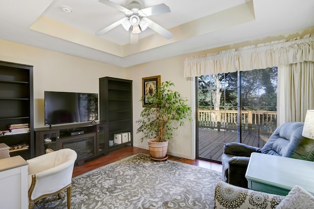 14 Rivendell Dr, Hayesville, NC 28904 - living room featuring a raised ceiling, wood finished floors, ceiling fan, and baseboards