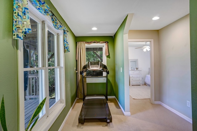 exercise room featuring ceiling fan and light colored carpet