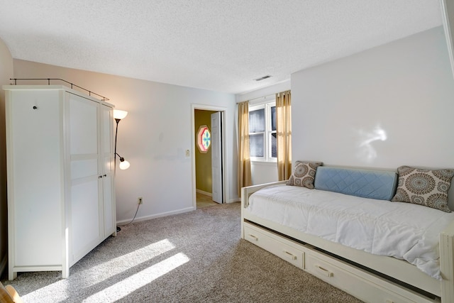 carpeted bedroom with a textured ceiling