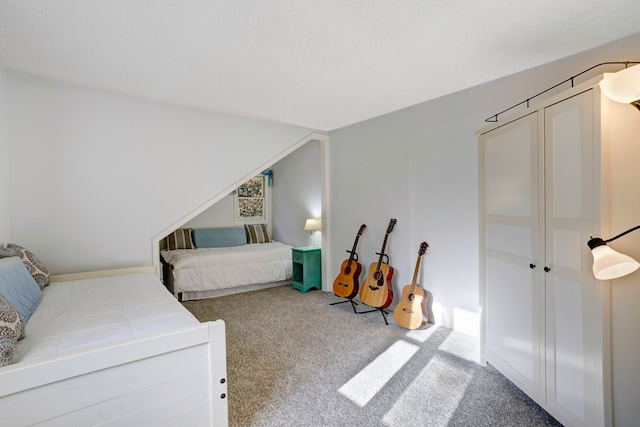 bedroom featuring carpet and a textured ceiling