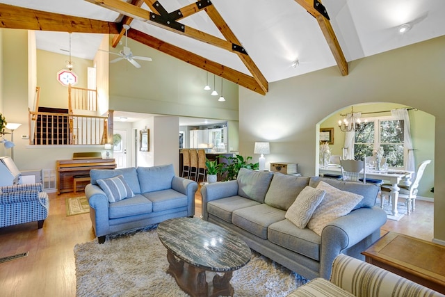 living room featuring beam ceiling, high vaulted ceiling, ceiling fan with notable chandelier, and hardwood / wood-style flooring