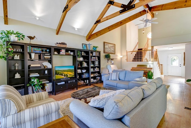 14 Rivendell Dr, Hayesville, NC 28904 - living area featuring stairway, beamed ceiling, wood finished floors, high vaulted ceiling, and a ceiling fan
