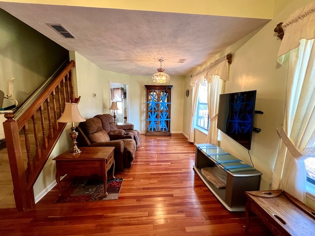 75 Briar Patch Dr, Covington, GA 30014 - living room with a chandelier, wood-type flooring, and a textured ceiling