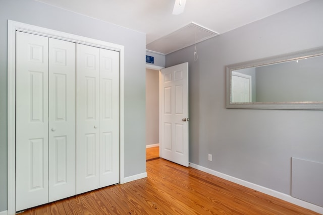 330 Ravens Gap Rd, Murphy, NC 28906 - unfurnished bedroom with attic access, wood finished floors, a closet, and a ceiling fan