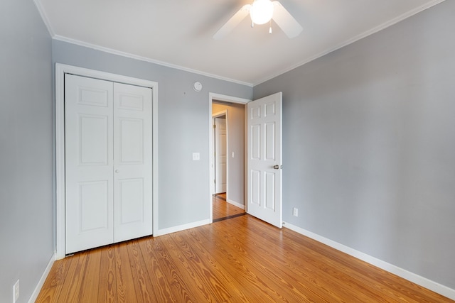 330 Ravens Gap Rd, Murphy, NC 28906 - unfurnished bedroom with wood finished floors, a closet, crown molding, and a ceiling fan