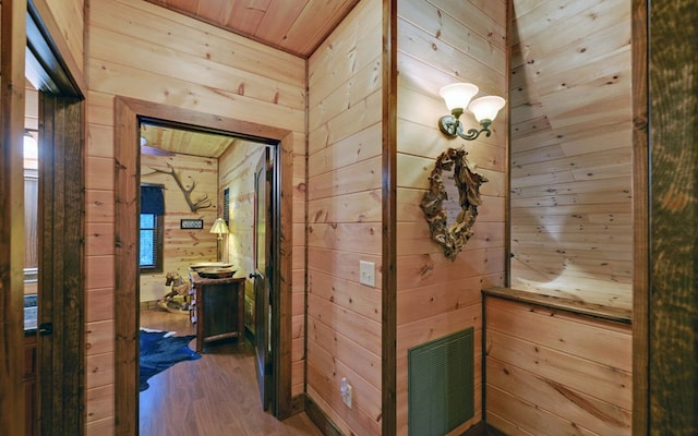corridor featuring wood walls, wood finished floors, and wood ceiling