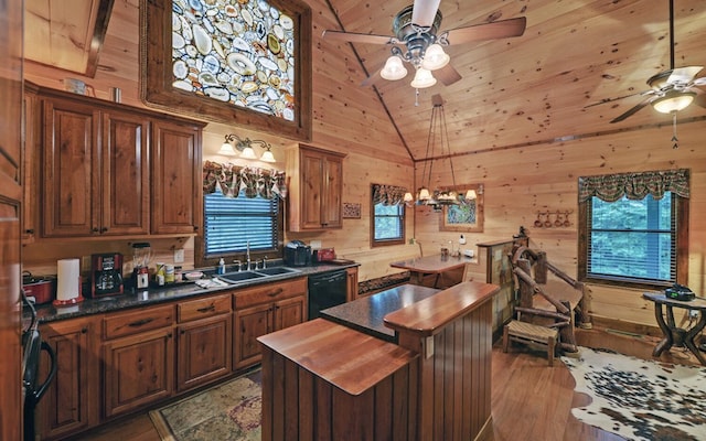 kitchen featuring ceiling fan, a sink, wood counters, black dishwasher, and a kitchen island