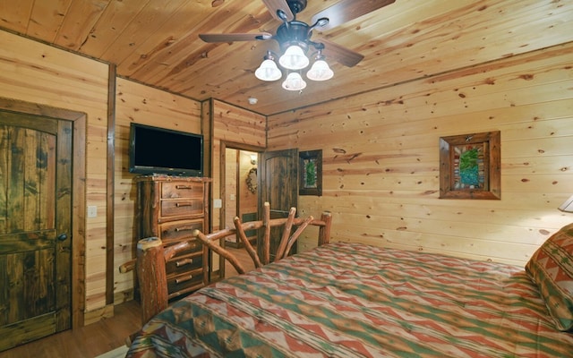 bedroom with wood walls, wooden ceiling, and wood finished floors