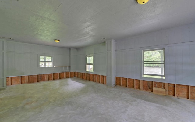 spare room featuring healthy amount of natural light and concrete floors