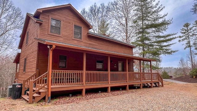 view of front of house with covered porch and central AC