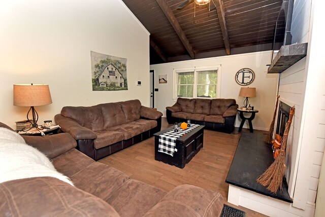 living room featuring ceiling fan, light hardwood / wood-style floors, lofted ceiling with beams, and wooden ceiling