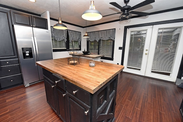 kitchen with stainless steel refrigerator with ice dispenser, dark wood-type flooring, a center island, and pendant lighting