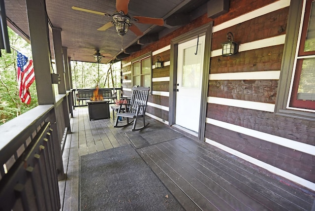 wooden terrace featuring ceiling fan and covered porch