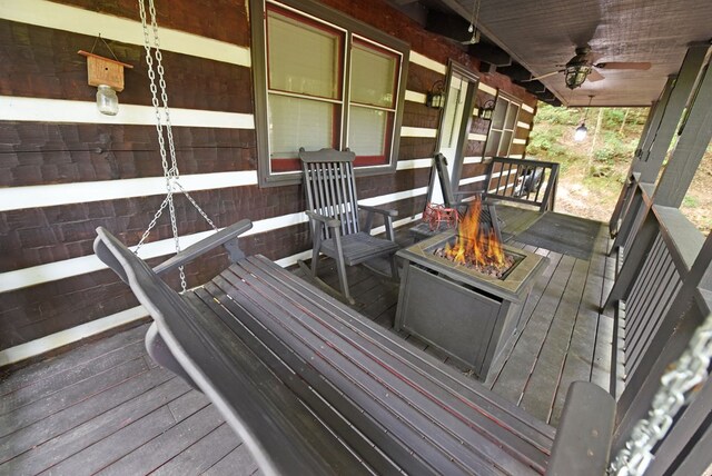 wooden terrace featuring ceiling fan