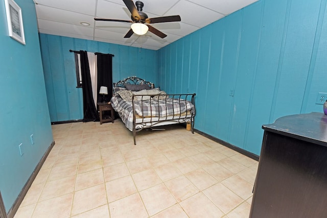 tiled bedroom featuring ceiling fan