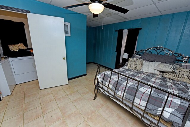 bedroom with washing machine and clothes dryer, a paneled ceiling, ceiling fan, and light tile patterned floors