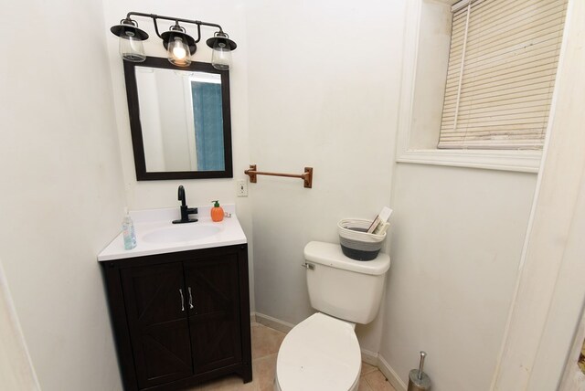 bathroom featuring vanity, toilet, and tile patterned floors