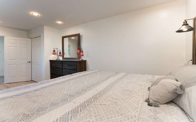 bedroom with a closet and light hardwood / wood-style floors