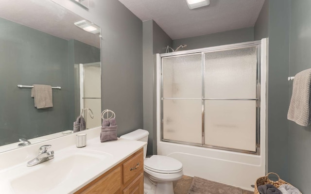 full bathroom with a textured ceiling, vanity, toilet, and enclosed tub / shower combo