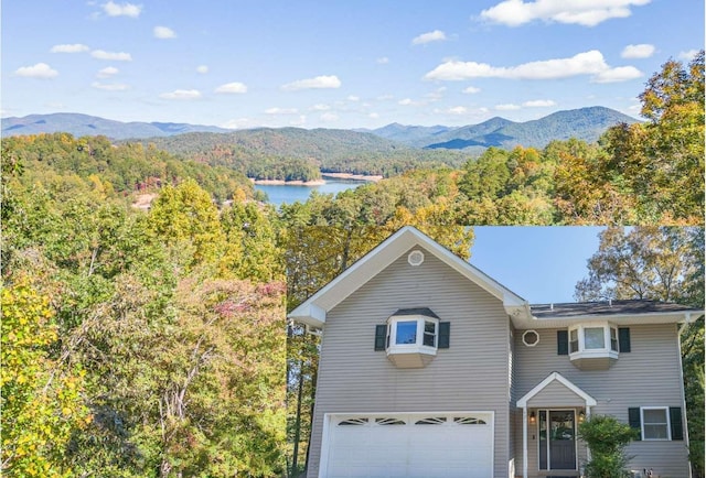 view of front facade featuring a garage and a water and mountain view