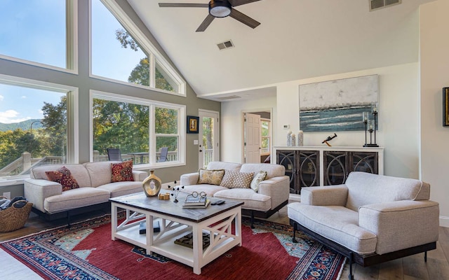 living room featuring ceiling fan, plenty of natural light, high vaulted ceiling, and wood-type flooring