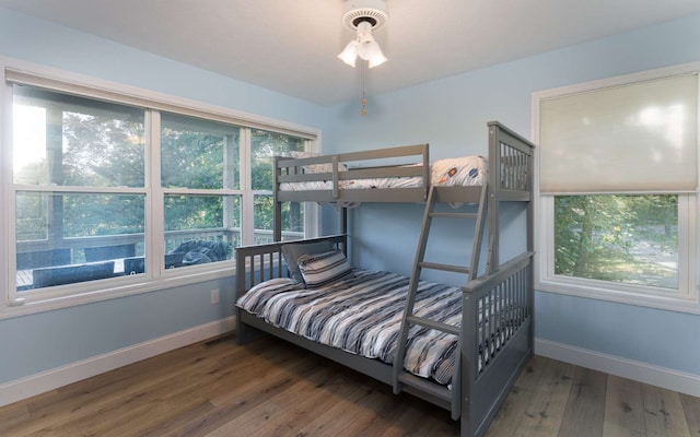 bedroom with dark hardwood / wood-style floors and ceiling fan