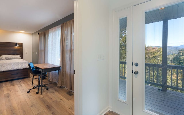 bedroom featuring french doors and light hardwood / wood-style floors