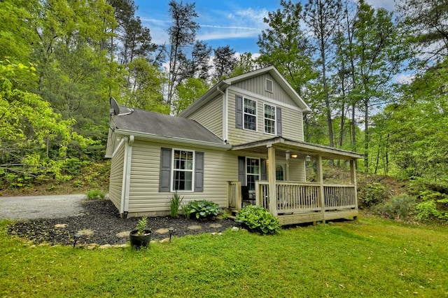 view of front of property featuring a porch, board and batten siding, and a front yard
