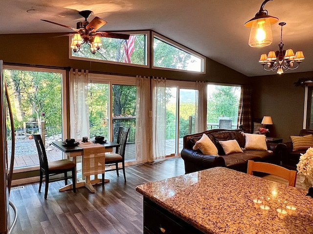 interior space with lofted ceiling, ceiling fan with notable chandelier, and dark hardwood / wood-style flooring