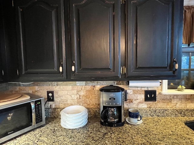 room details with backsplash and light stone countertops