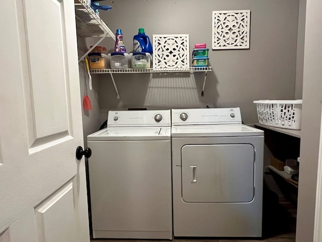 clothes washing area featuring separate washer and dryer