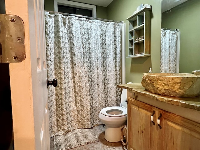 bathroom featuring vanity, toilet, and tile patterned flooring