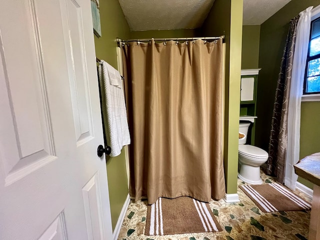 bathroom featuring toilet and a textured ceiling