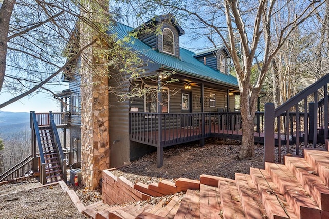 back of property featuring a deck with mountain view