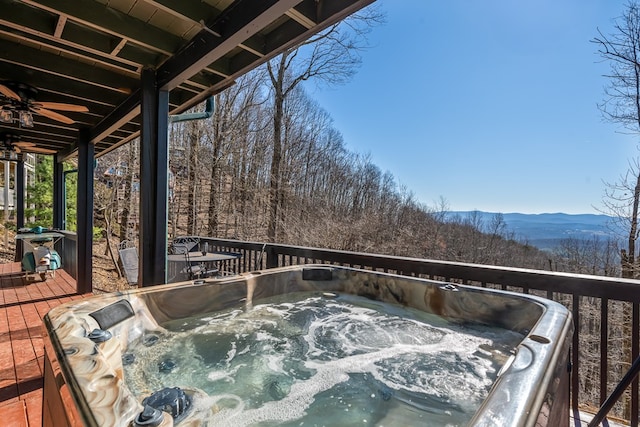 deck featuring a mountain view and a hot tub