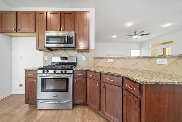 238 Balsam Dr, Canton, GA 30114 - kitchen with stainless steel appliances, light stone counters, a ceiling fan, light wood finished floors, and backsplash