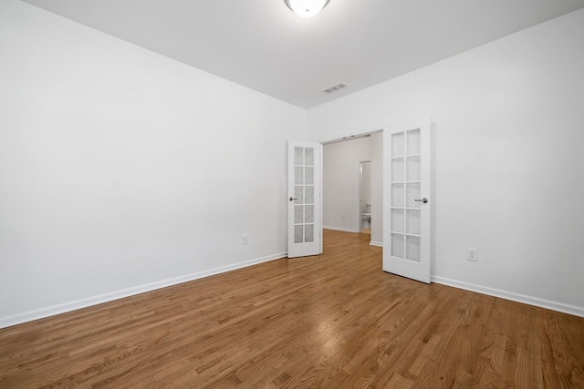 238 Balsam Dr, Canton, GA 30114 - unfurnished bedroom featuring french doors and wood finished floors
