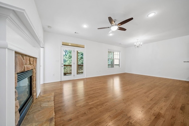 238 Balsam Dr, Canton, GA 30114 - unfurnished living room with a ceiling fan, a fireplace, a chandelier, wood finished floors, and recessed lighting